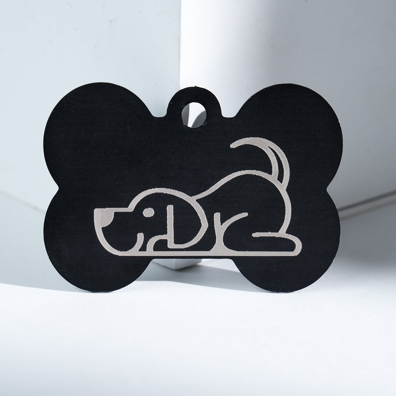 The Creality Falcon Large Multicolor Anodized Aluminum Dog Tag features a simple white line drawing of a playful dog standing upright, engraved on the tag's surface.